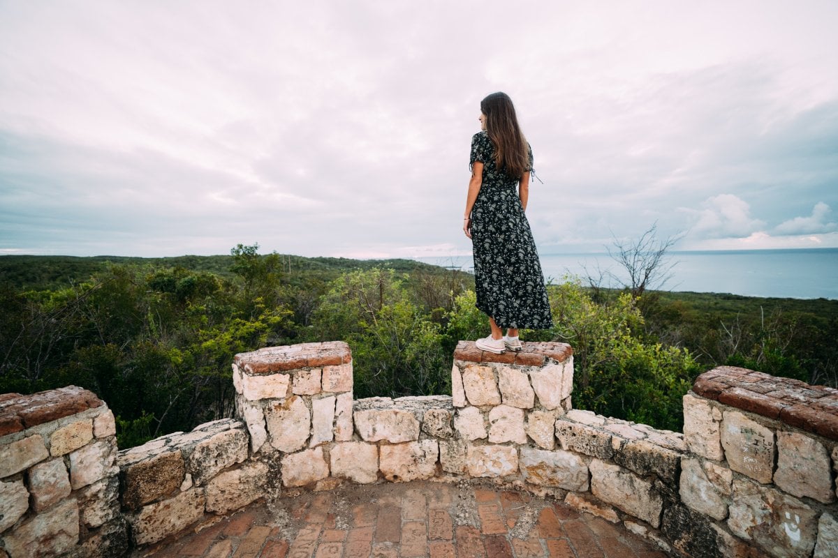 Hiker overlooking Guánica Dry Forest from Fuerte Caprón, one of the top hikes in Puerto Rico.