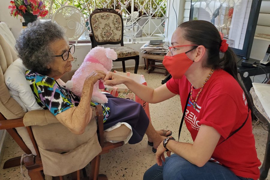 A volunteer nurse looks after an elderly woman in Puerto Rico. 