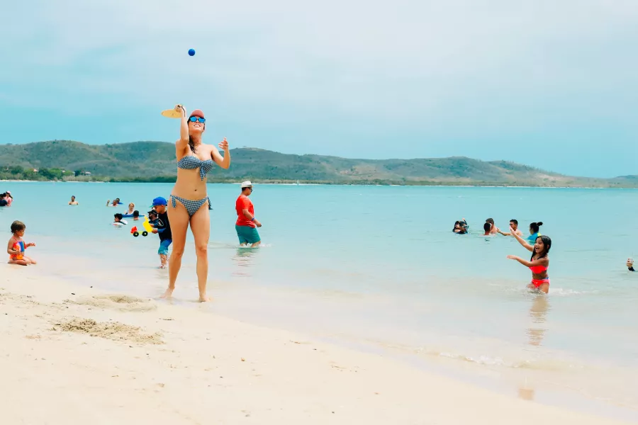 Beachgoers play games on Combate Beach in Cabo Rojo