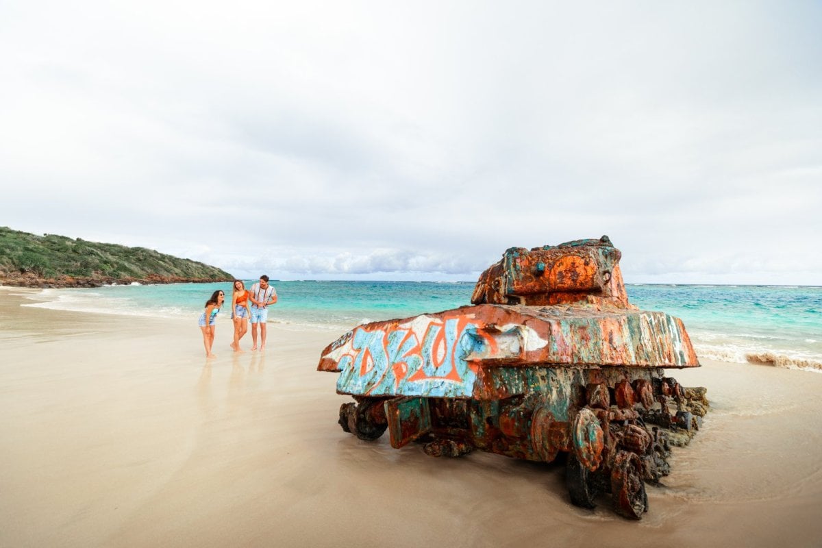 Group visiting Flamenco Beach and its famous rusted tank in Culebra, Puerto Rico