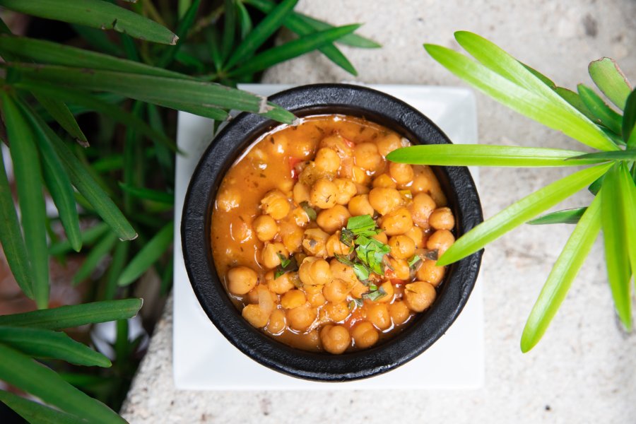 A heart bowl of stewed garbanzos, a traditional dish in Puerto Rico.