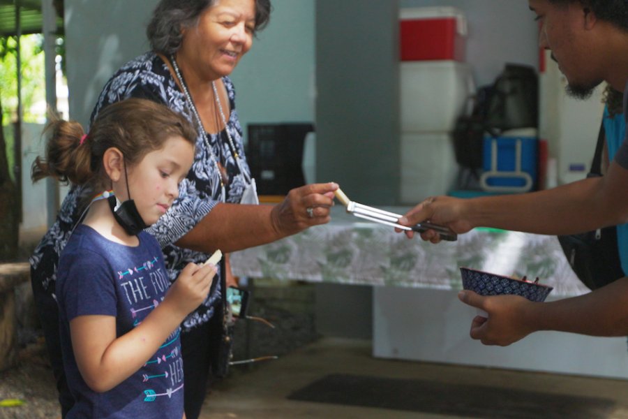 Two people receiving a dish of food from a soup kitchen in Puerto Rico.