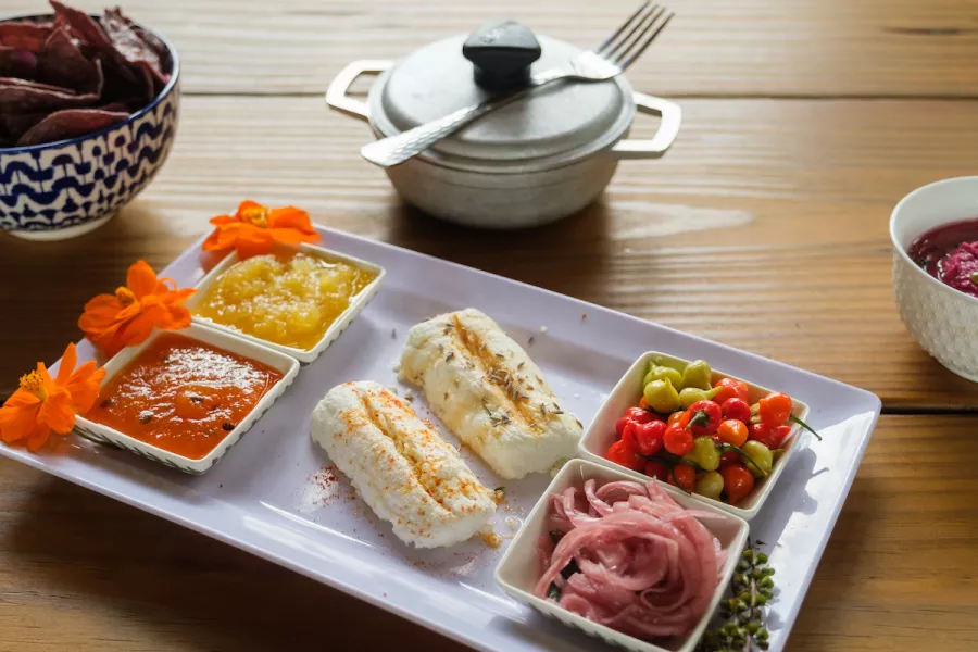 A white-fleshed fish dish with various accompaniments served at Frutos del Guacabo, a farm-to-fork farm and restaurant in Manati, Puerto Rico.