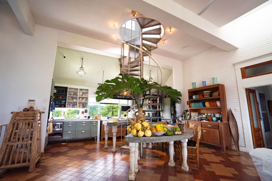 Image of inside of one of the 4 Casitas with a table full of fruits , stair and rustic furniture. 