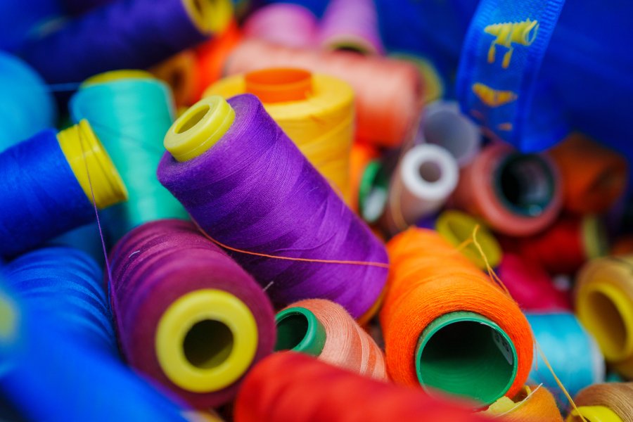 A colorful collection of spool of thread.