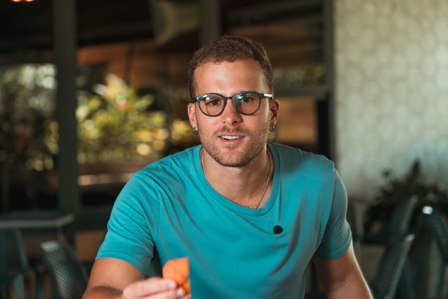A person holding a papaya at Finca la Zafra in Gurabo, Puerto Rico
