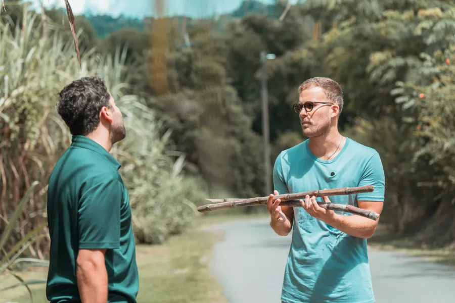 Two people holding sugarcane at Finca la Zafra in Gurabo, Puerto Rico.