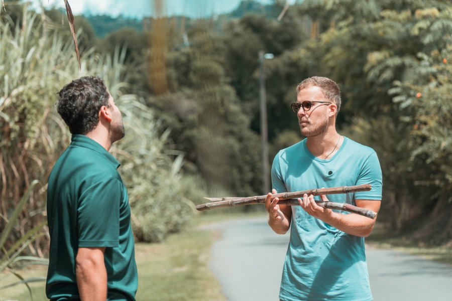 Two people holding sugarcane at Finca la Zafra in Gurabo, Puerto Rico.