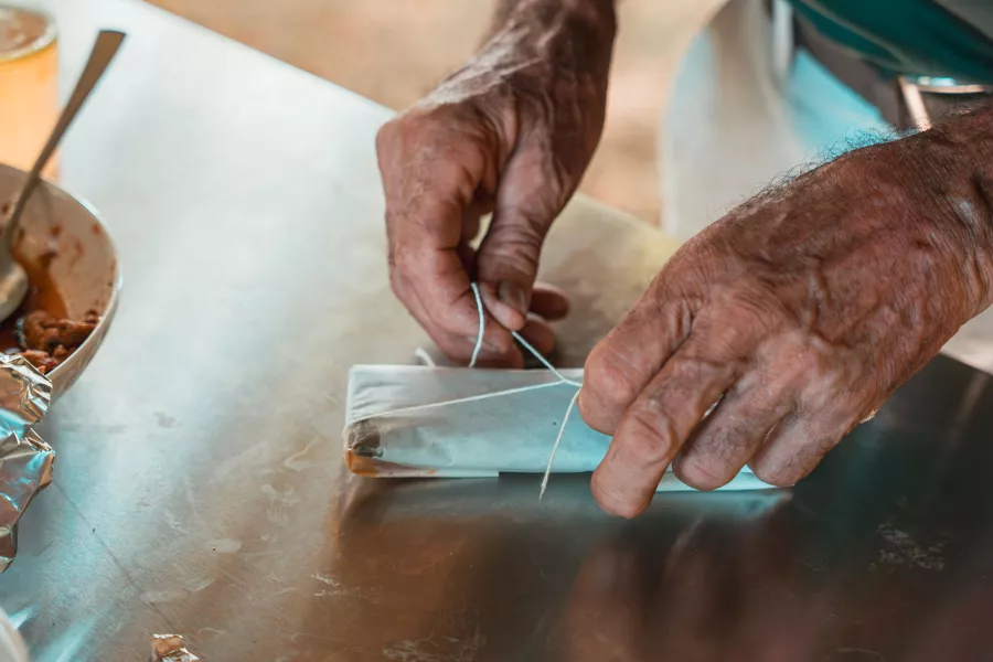 A person wrapping a pastel, a traditional holiday treat, at Finca la Zafra in Gurabo, Puerto Rico