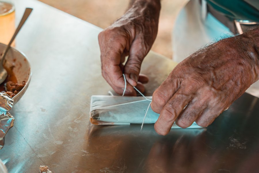 A person wrapping a pastel, a traditional holiday treat, at Finca la Zafra in Gurabo, Puerto Rico