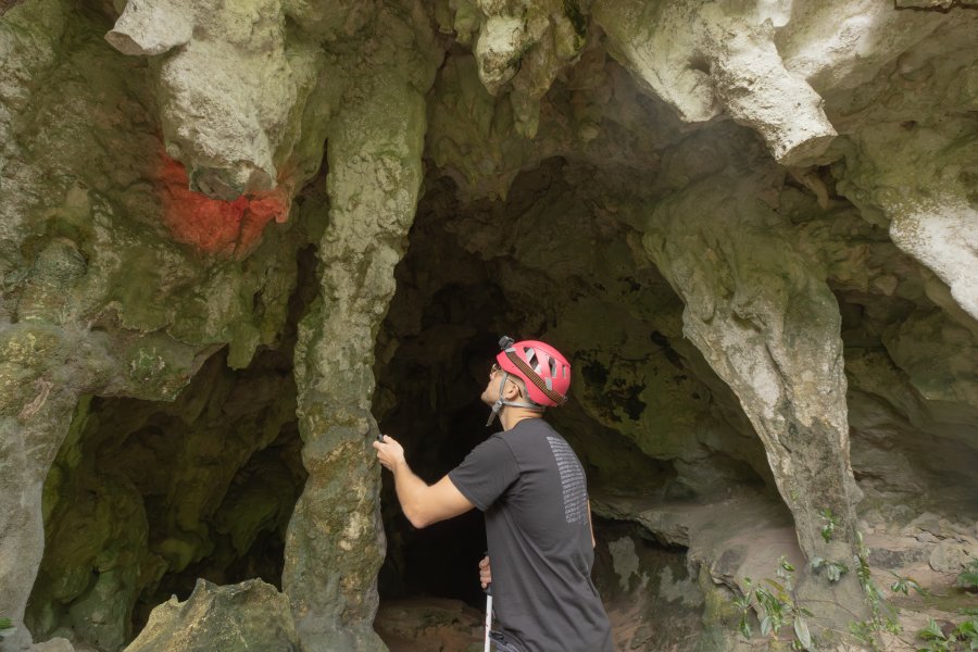 A person observing stalactites at the Cabachuelas Natural Reserves in Morovis, Puerto Rico.