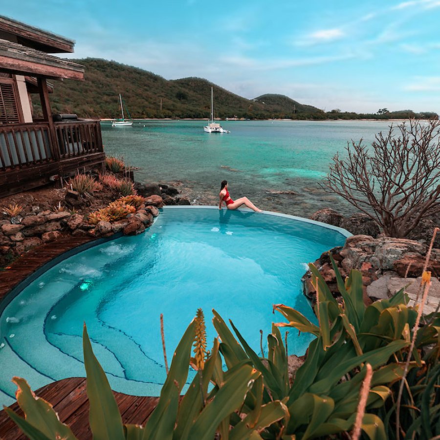Woman enjoying ocean view from private pool at Puerto Rico rental home