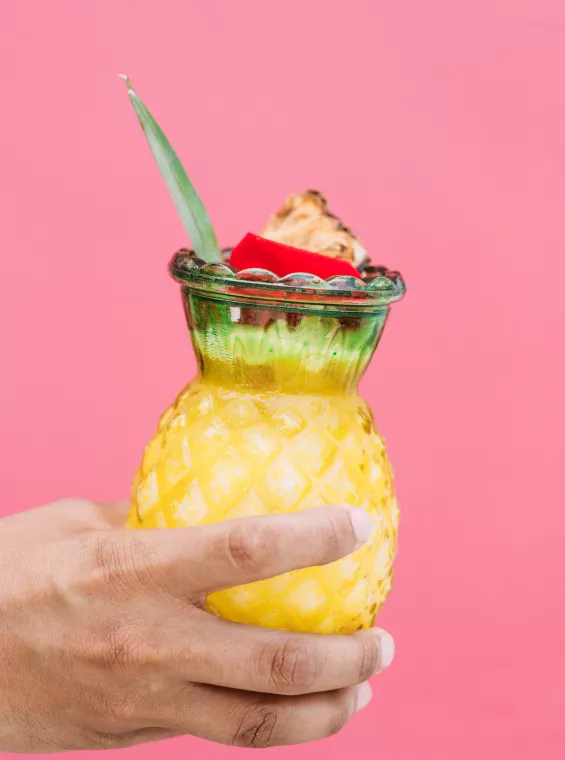 Puerto Rico's national drink, the piña colada, served in a fun pineapple-shapped glass.