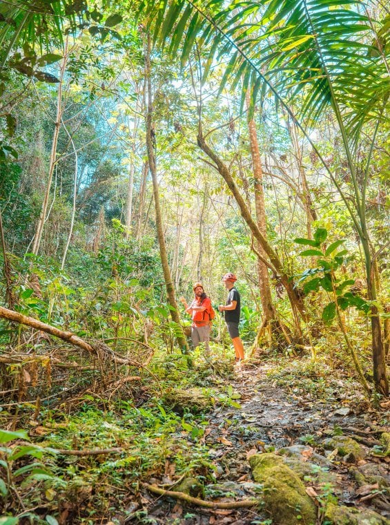 Two people walking on the hiking trails at the Cabachuelas Nature Reserve in Morovis, Puerto Rico